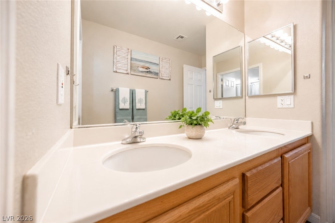 Double sinks and a spacious vanity enhance this functional master bathroom.