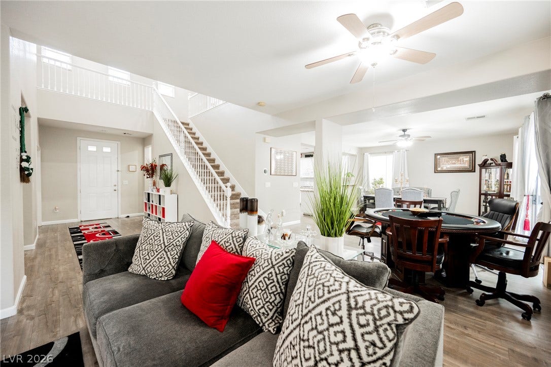 Gleaming wood-look floors complement an airy, multi-level layout filled with natural light.