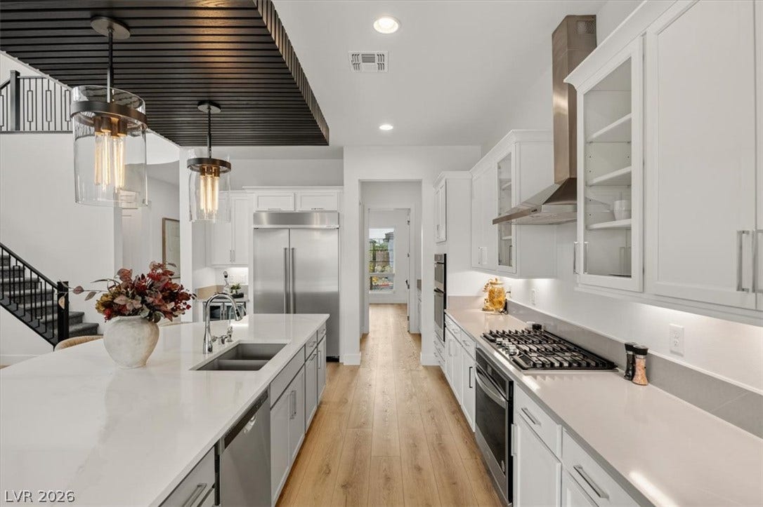 2611 Nevada Agave Lane, Las Vegas, NV 89138 Warm wood flooring and clean stone counters define this modern, gourmet culinary space.
