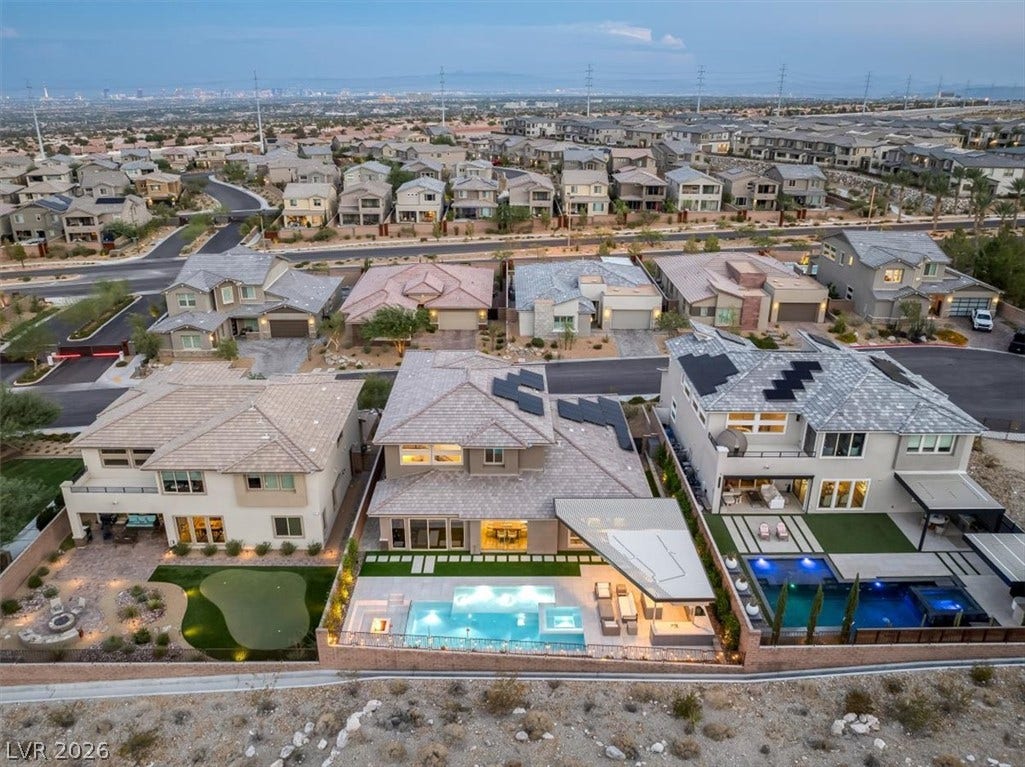 2611 Nevada Agave Lane, Las Vegas, NV 89138 An aerial perspective captures the backyard swimming pool and distant city skyline views.