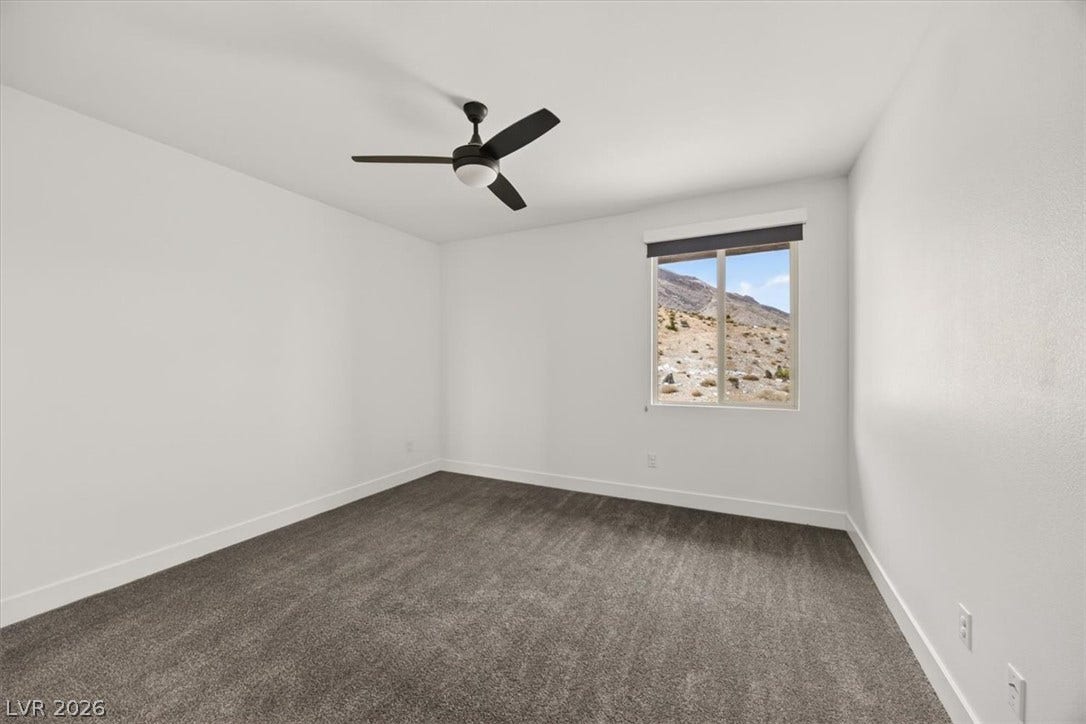 2611 Nevada Agave Lane, Las Vegas, NV 89138 Plush carpeting and a picture window overlooking rugged desert hills define this space.