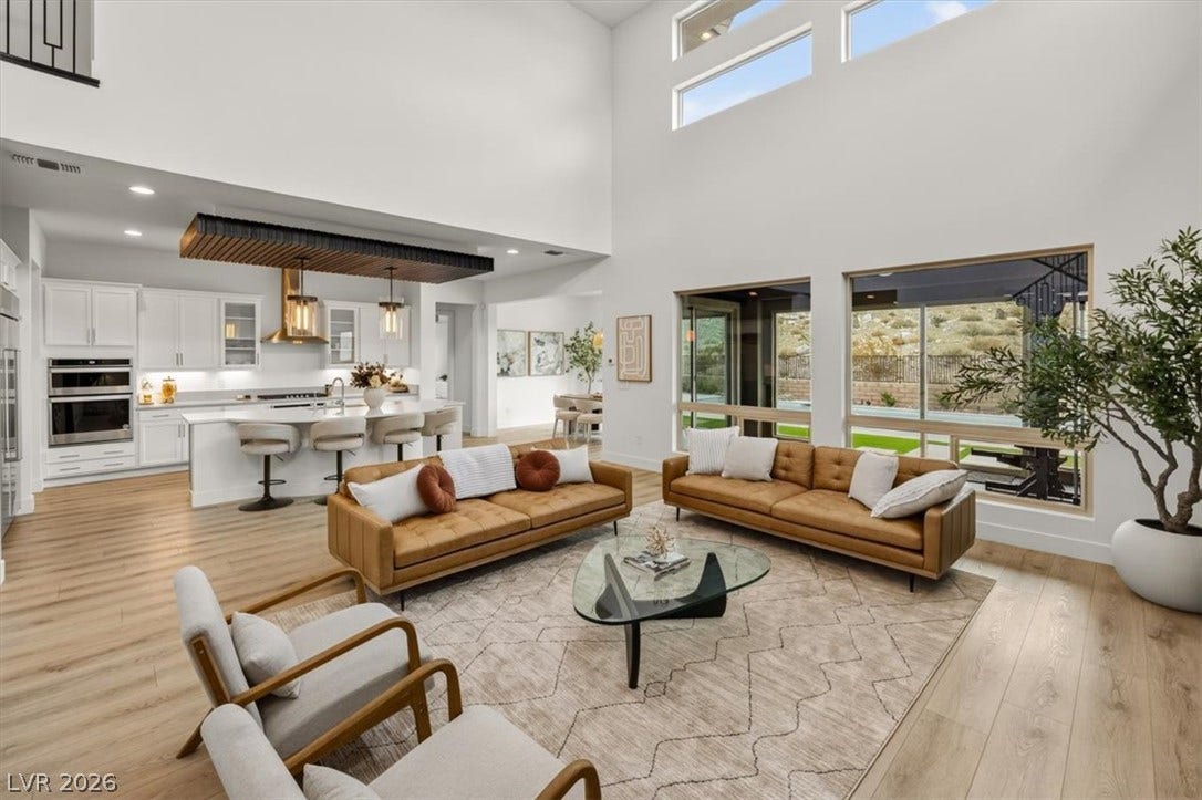 2611 Nevada Agave Lane, Las Vegas, NV 89138 Towering ceilings and multi-tiered windows illuminate this airy, open-concept living space.