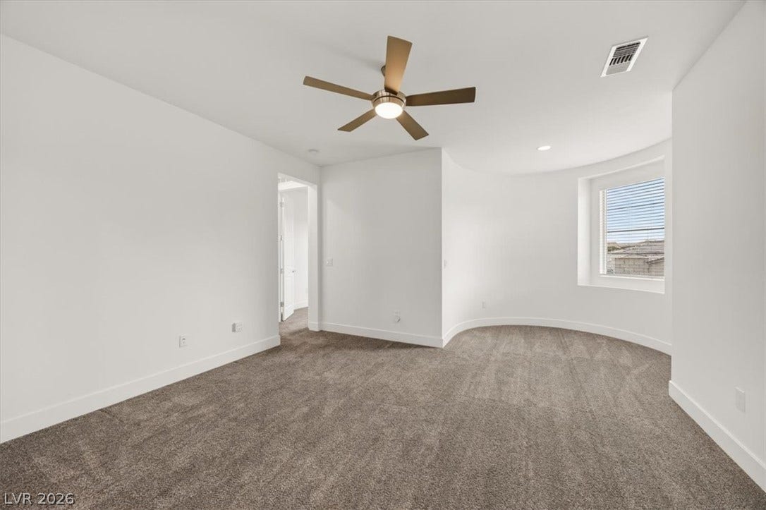 2611 Nevada Agave Lane, Las Vegas, NV 89138 Plush carpeting anchors this versatile room detailed with a distinctive curved wall.