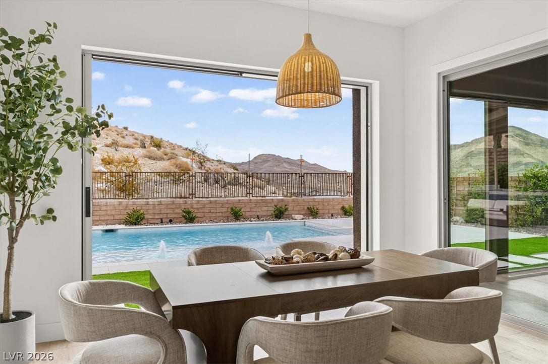 2611 Nevada Agave Lane, Las Vegas, NV 89138 Wide sliding glass doors connect the dining area directly to the backyard pool patio.