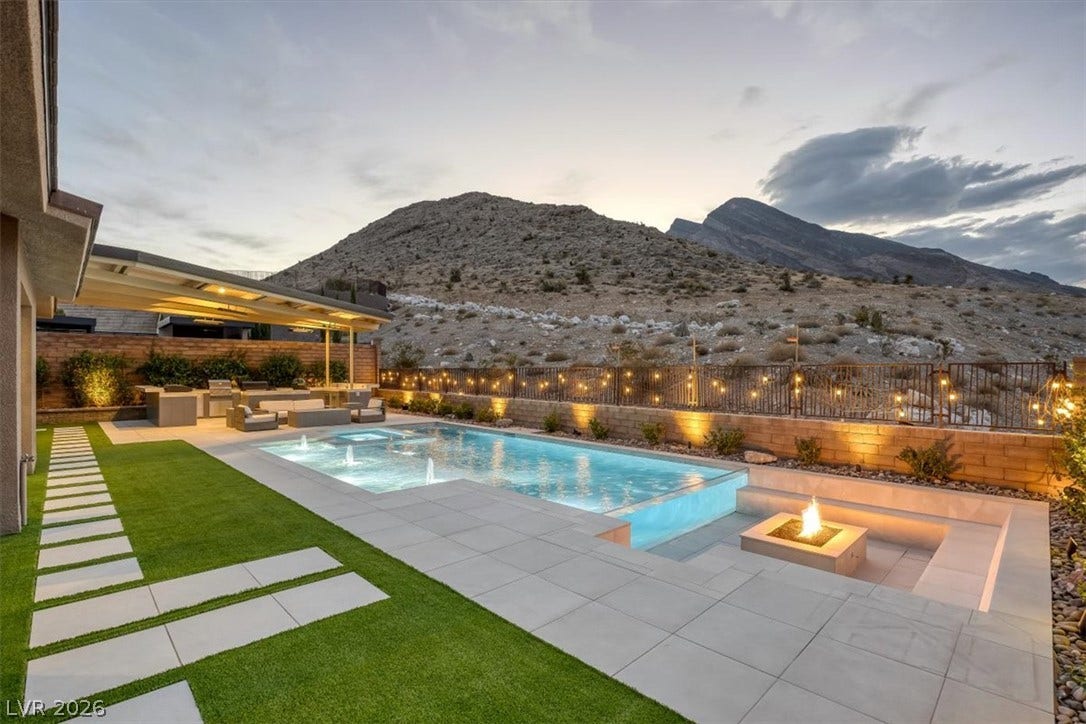 2611 Nevada Agave Lane, Las Vegas, NV 89138 A sparkling swimming pool rests against a dramatic mountain backdrop.
