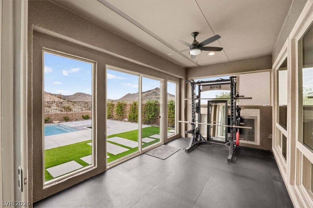 2611 Nevada Agave Lane, Las Vegas, NV 89138 Expansive glass doors open this versatile indoor space directly to the backyard pool deck.