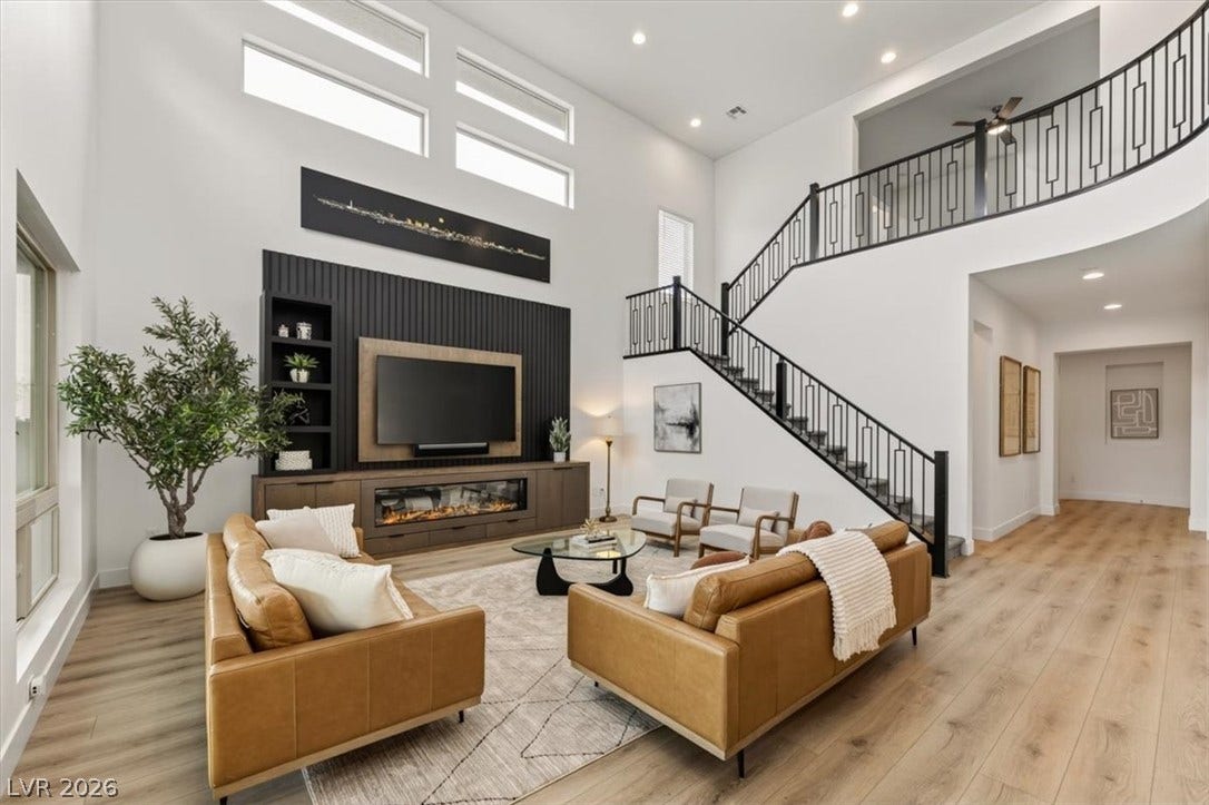 2611 Nevada Agave Lane, Las Vegas, NV 89138 Towering ceilings and a sweeping staircase elevate this modern main living space.