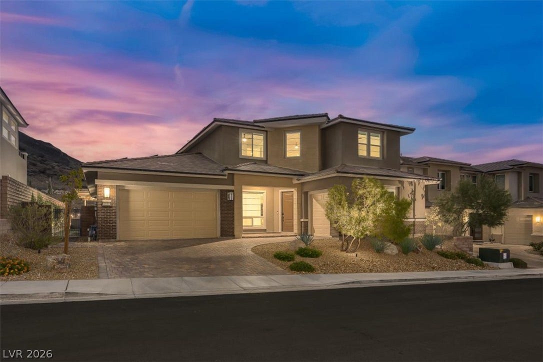 2611 Nevada Agave Lane, Las Vegas, NV 89138 A modern two-story exterior showcases stucco and brick finishes alongside a paved driveway.