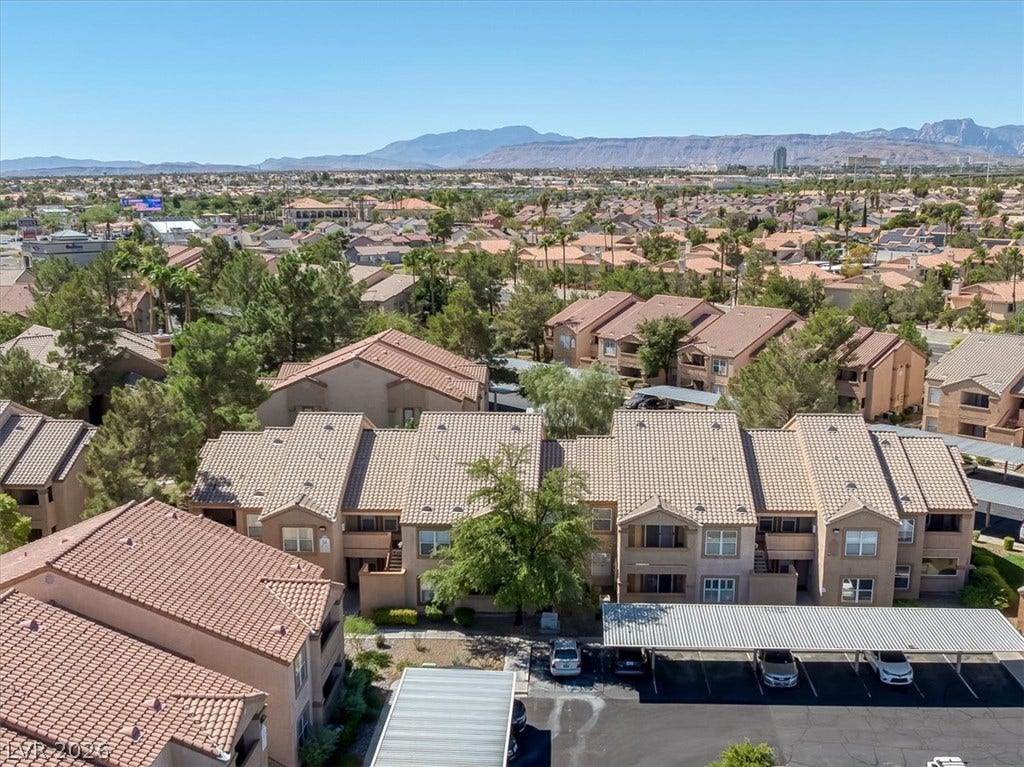 Distant mountains frame a wide perspective of the surrounding residential neighborhood.