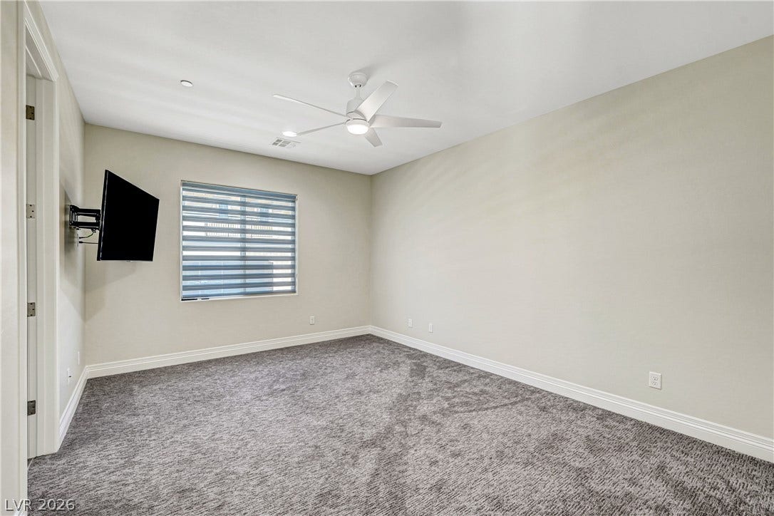 89 Olympia Chase Drive, Las Vegas, NV 89141 Plush wall-to-wall carpeting and clean baseboards define this versatile secondary space.