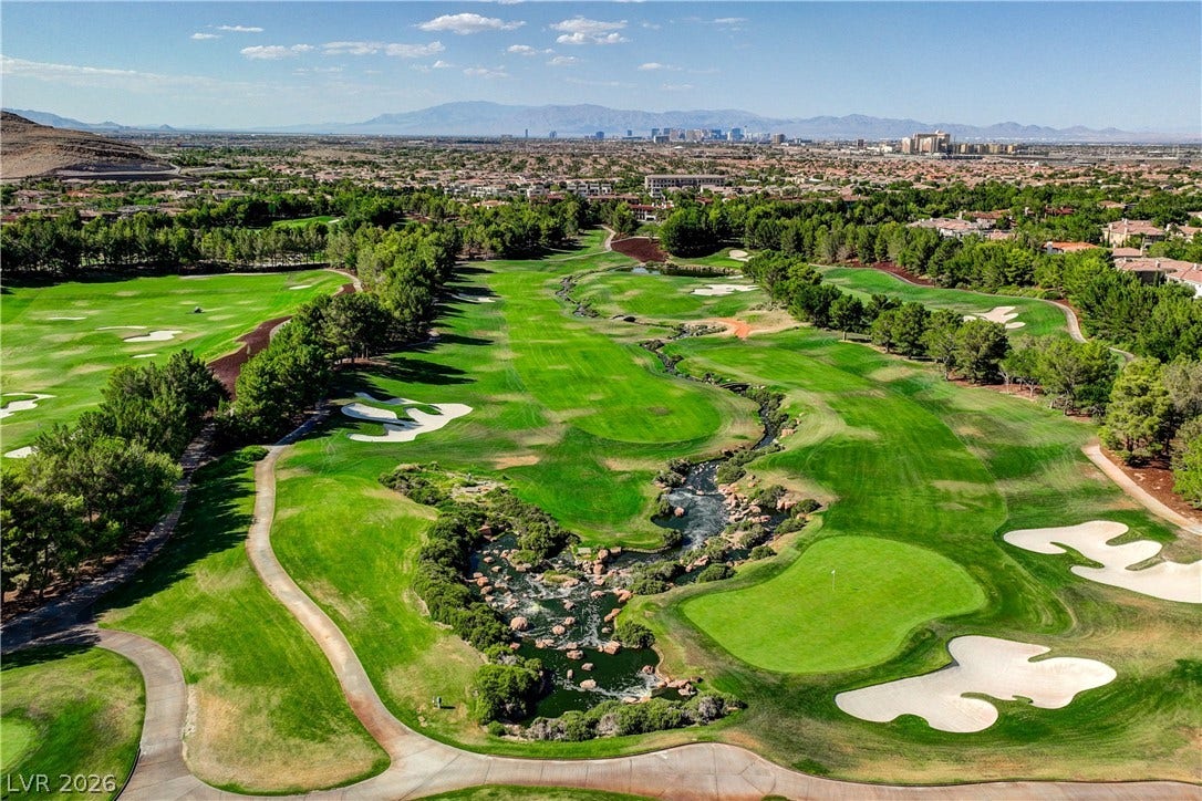 89 Olympia Chase Drive, Las Vegas, NV 89141 Lush fairways and a winding water feature define this championship golf course setting.