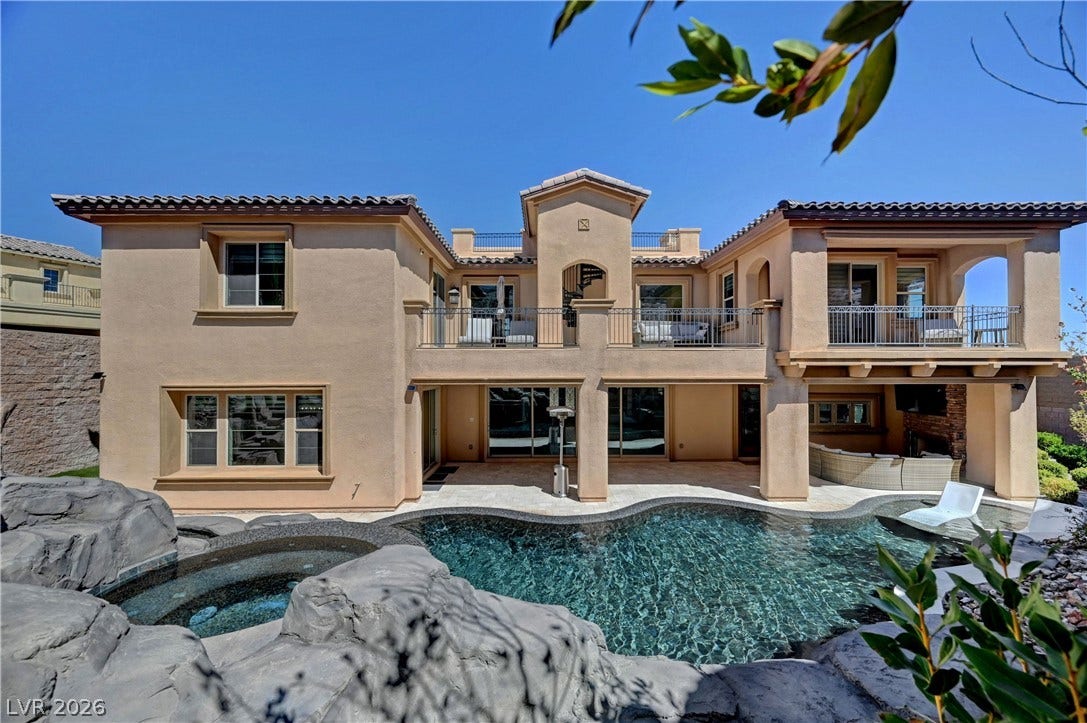 89 Olympia Chase Drive, Las Vegas, NV 89141 An inviting backyard oasis features a custom-designed pool framed by elegant Spanish tile roofing.