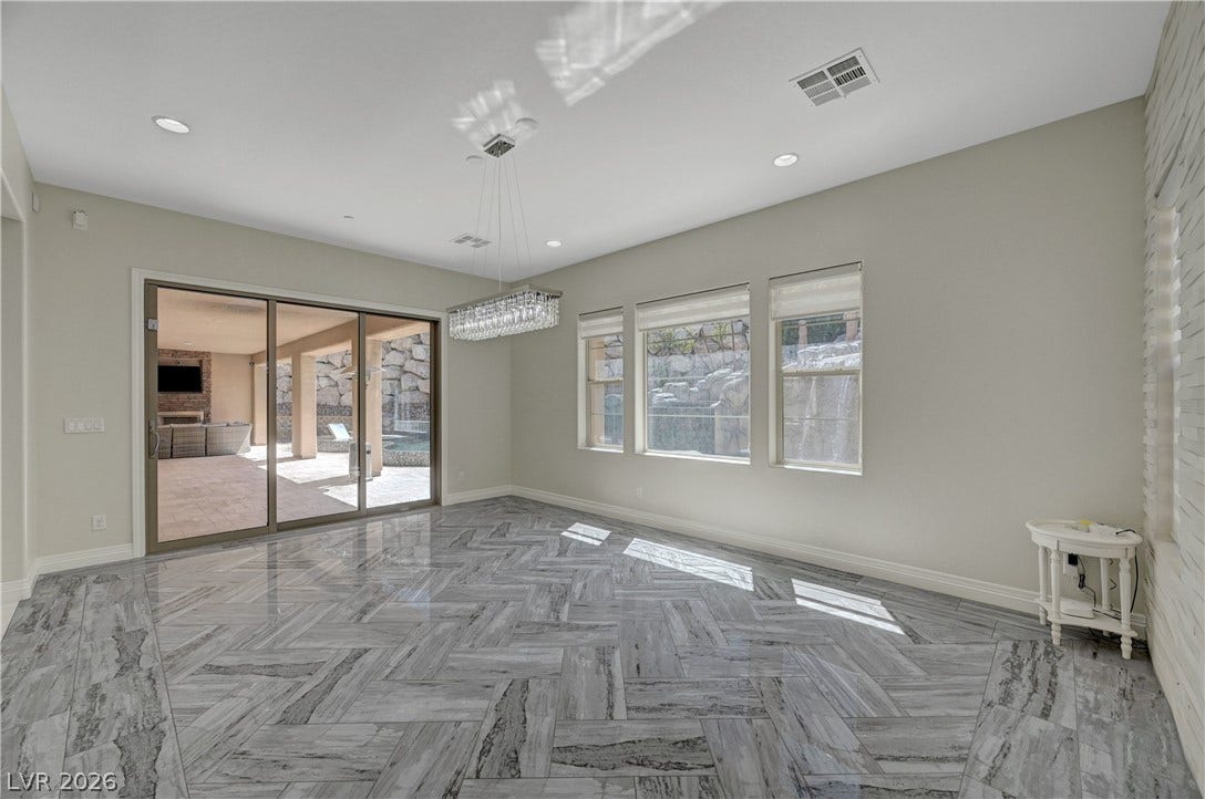 89 Olympia Chase Drive, Las Vegas, NV 89141 Gleaming tile floors in a herringbone pattern ground this airy room with outdoor access.