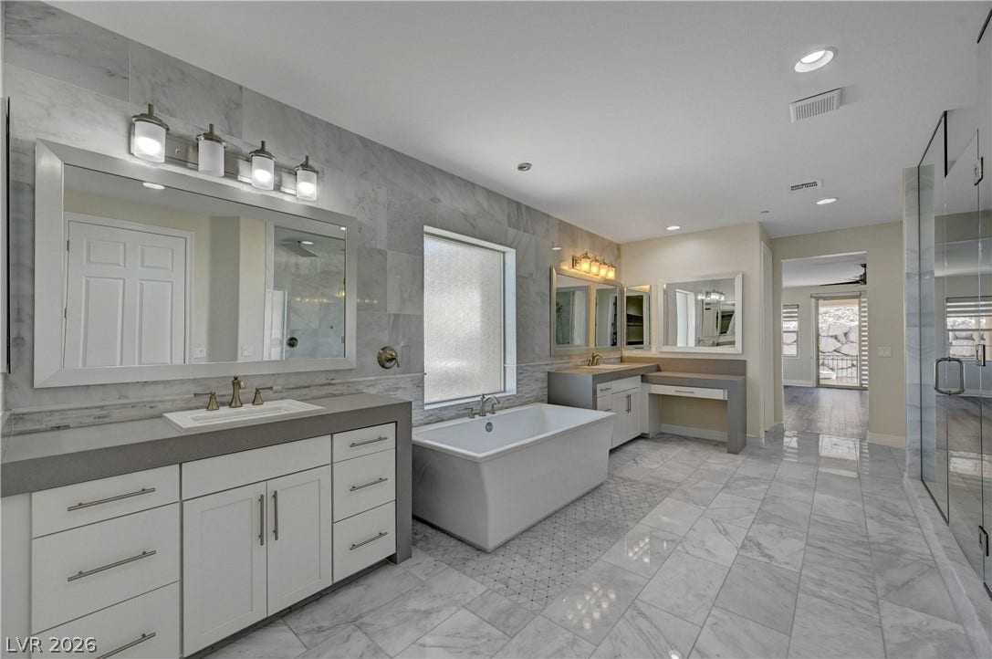 89 Olympia Chase Drive, Las Vegas, NV 89141 Polished tile floors and clean modern lines define this beautifully appointed washroom.