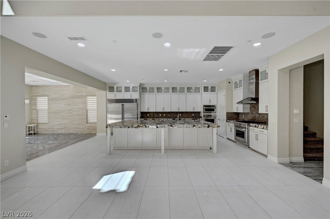 89 Olympia Chase Drive, Las Vegas, NV 89141 An expansive open floor plan highlights a gourmet kitchen with seamless tile flooring.