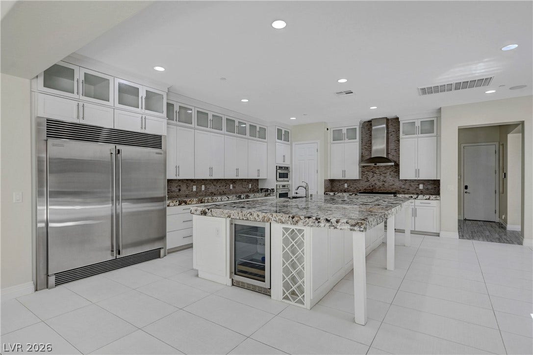 89 Olympia Chase Drive, Las Vegas, NV 89141 Gleaming stone countertops and stainless steel appliances anchor this light-filled gourmet space.