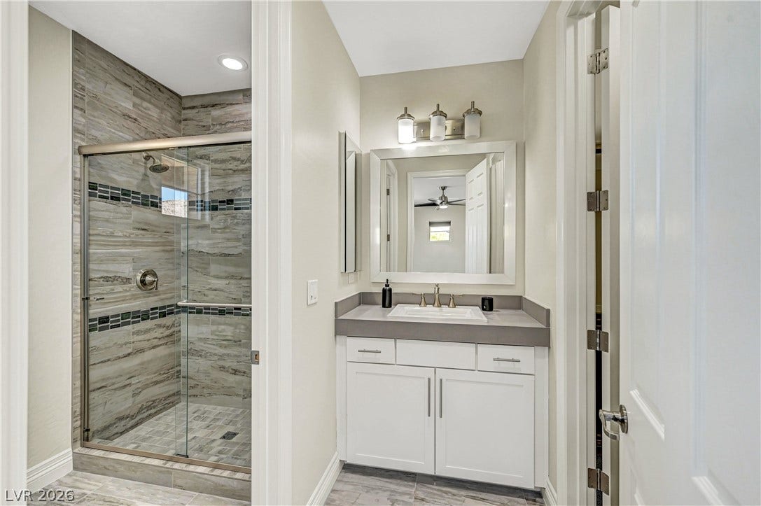 89 Olympia Chase Drive, Las Vegas, NV 89141 Modern tile selections define this beautifully updated bathroom space.