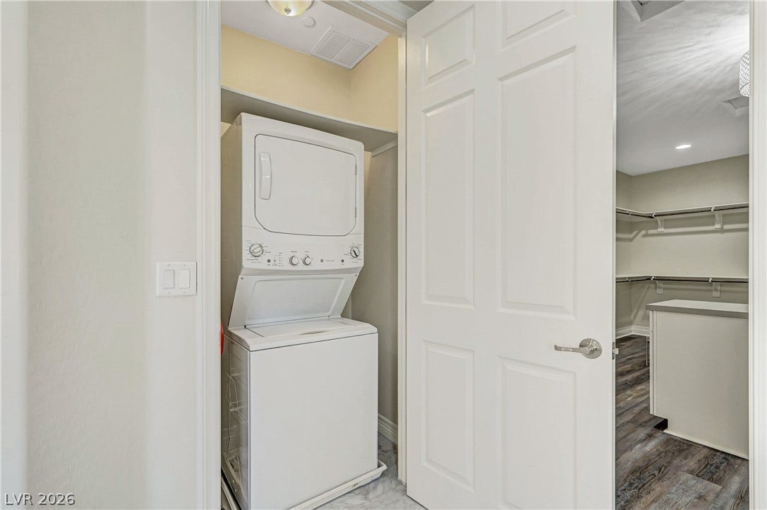 89 Olympia Chase Drive, Las Vegas, NV 89141 A stacked laundry setup is conveniently situated just off the walk-in closet.