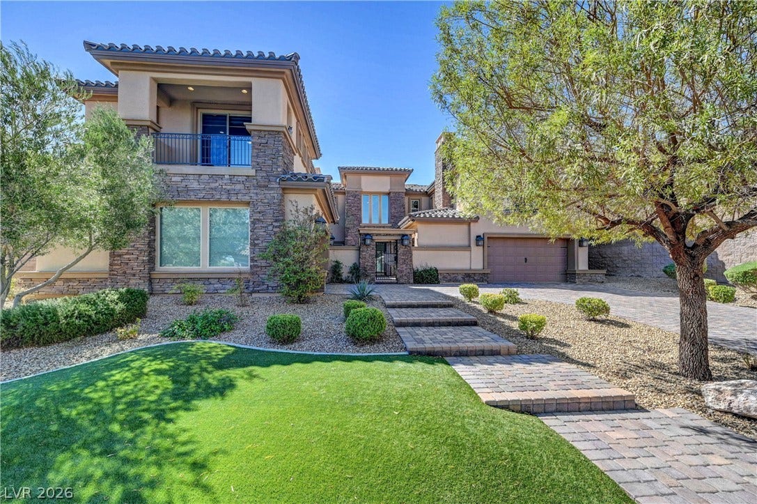 89 Olympia Chase Drive, Las Vegas, NV 89141 Exquisite stone accents and a paved pathway create an impressive approach to this elegant home.