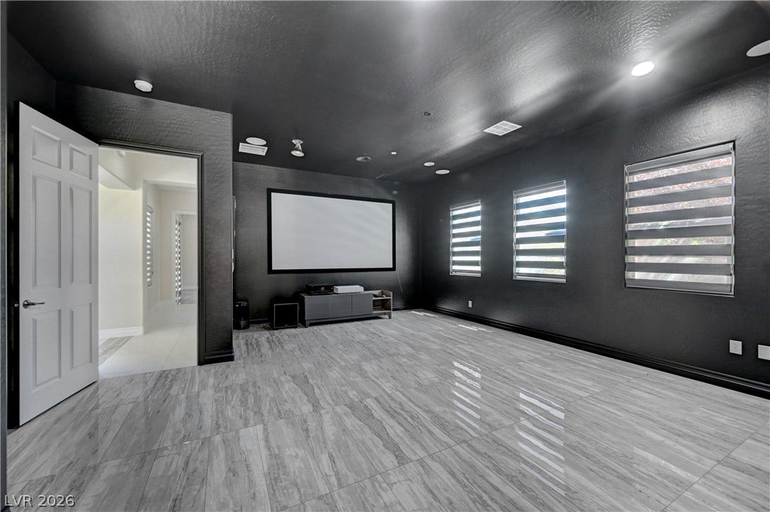 89 Olympia Chase Drive, Las Vegas, NV 89141 Polished tile flooring and dark walls create an immersive home theater experience.
