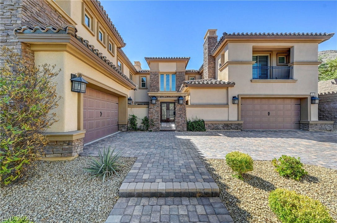 89 Olympia Chase Drive, Las Vegas, NV 89141 Stone accents and a paved driveway welcome visitors to this Mediterranean-style estate.