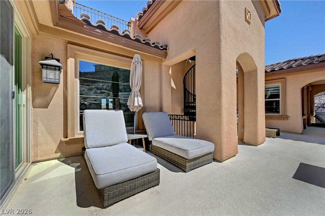 89 Olympia Chase Drive, Las Vegas, NV 89141 Smooth stucco arches and Spanish tile roofs define this sun-drenched outdoor terrace.