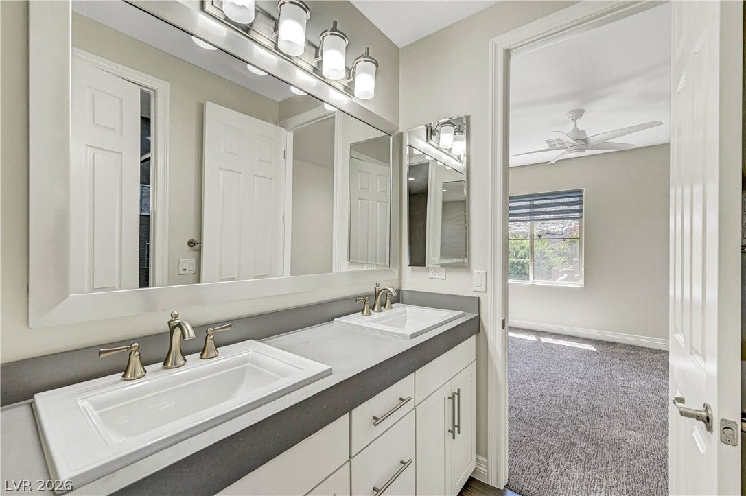 89 Olympia Chase Drive, Las Vegas, NV 89141 Clean lines and a spacious dual vanity define this modern bathroom.