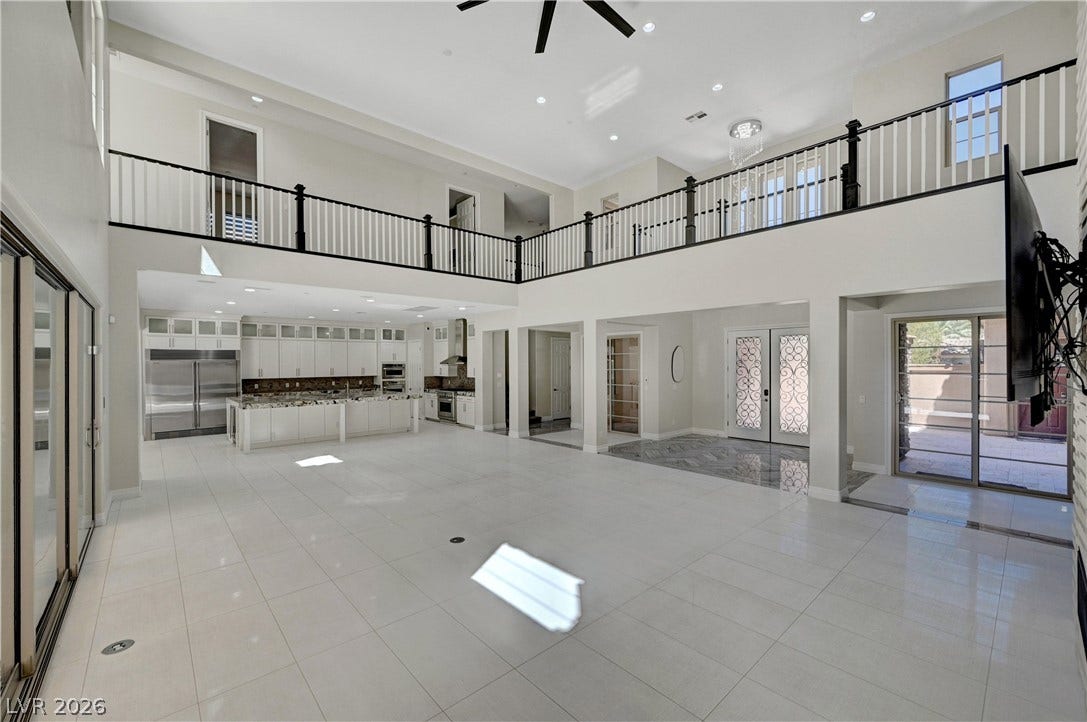 89 Olympia Chase Drive, Las Vegas, NV 89141 Polished tile flooring and an overhead catwalk define this soaring, open-concept living pavilion.