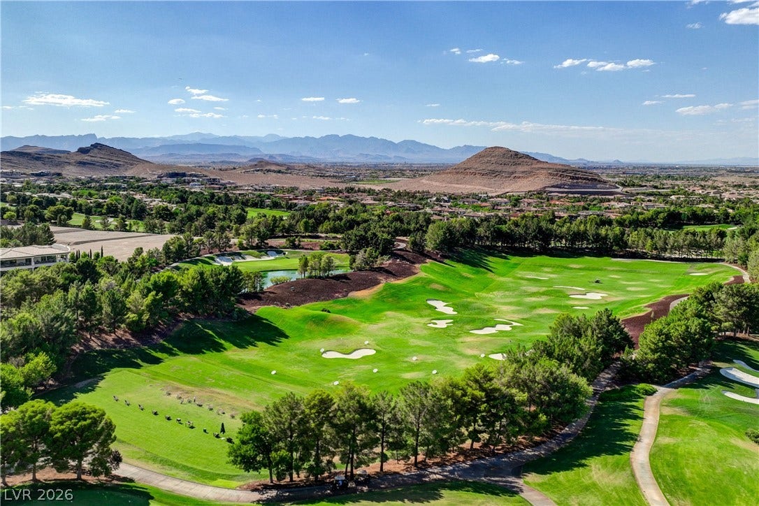89 Olympia Chase Drive, Las Vegas, NV 89141 Panoramas of the emerald golf course greens unfold against a majestic mountain backdrop.