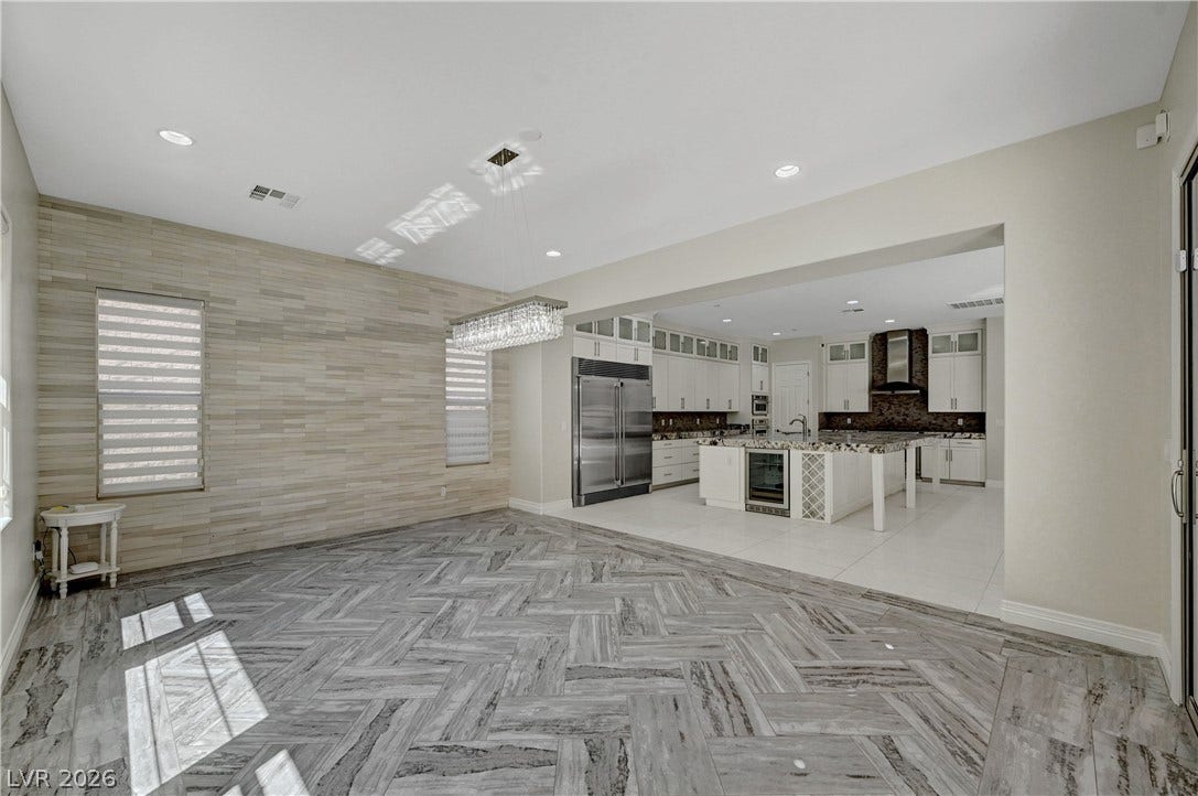 89 Olympia Chase Drive, Las Vegas, NV 89141 Gleaming tiled floors lay the foundation for this airy, open-concept dining area and kitchen.