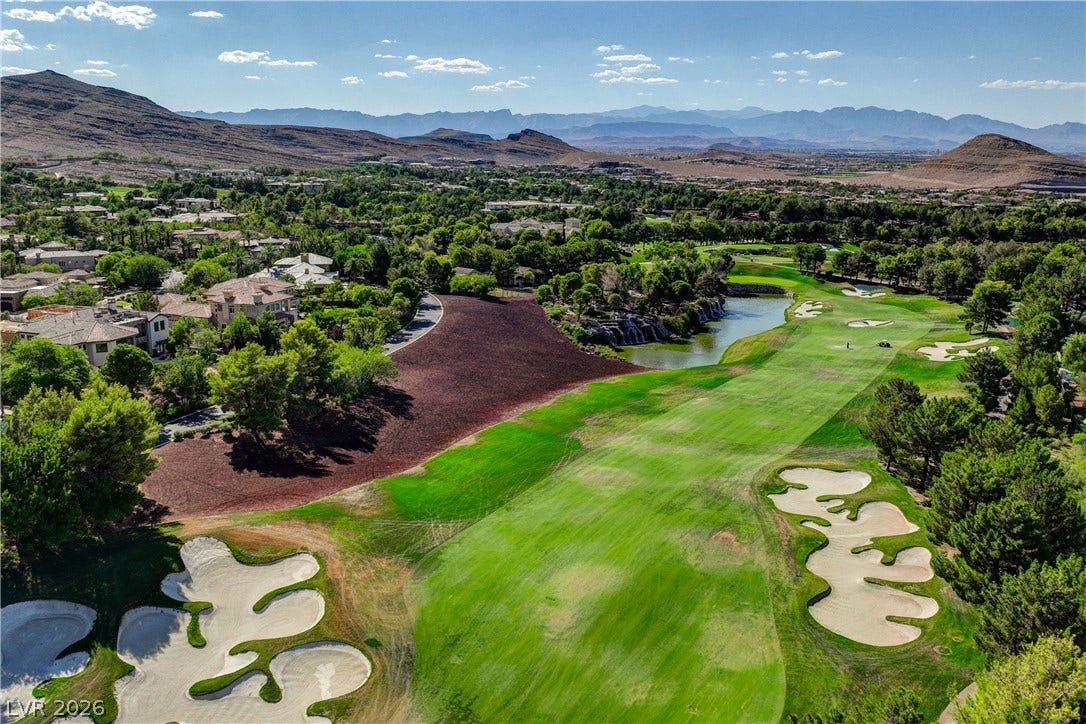 89 Olympia Chase Drive, Las Vegas, NV 89141 Sweeping mountain and desert views frame this verdant golf course landscape.