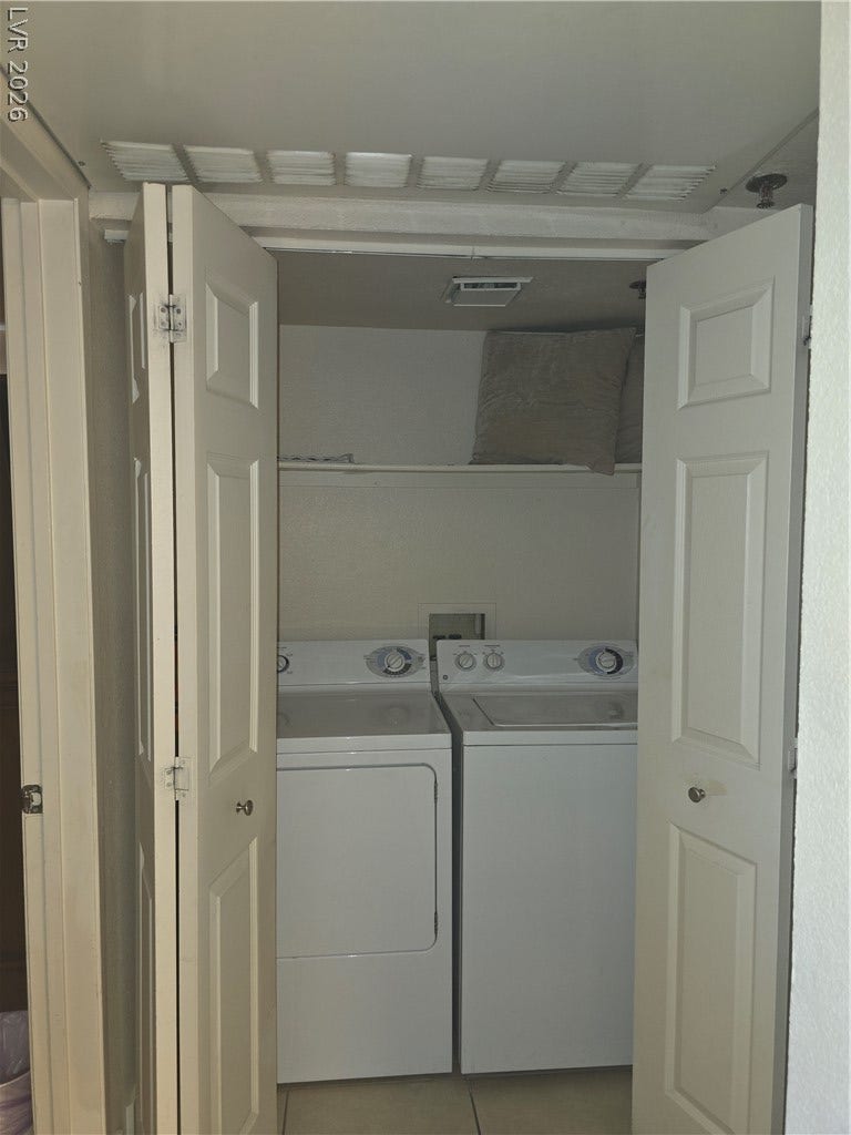 A dedicated laundry closet keeps household essentials tucked away behind folding doors.