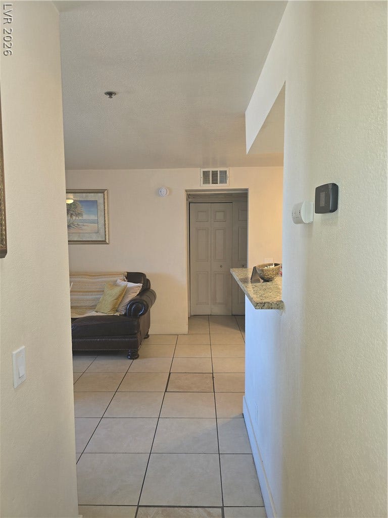 Durable tile flooring spans this welcoming entryway leading into the central living areas.