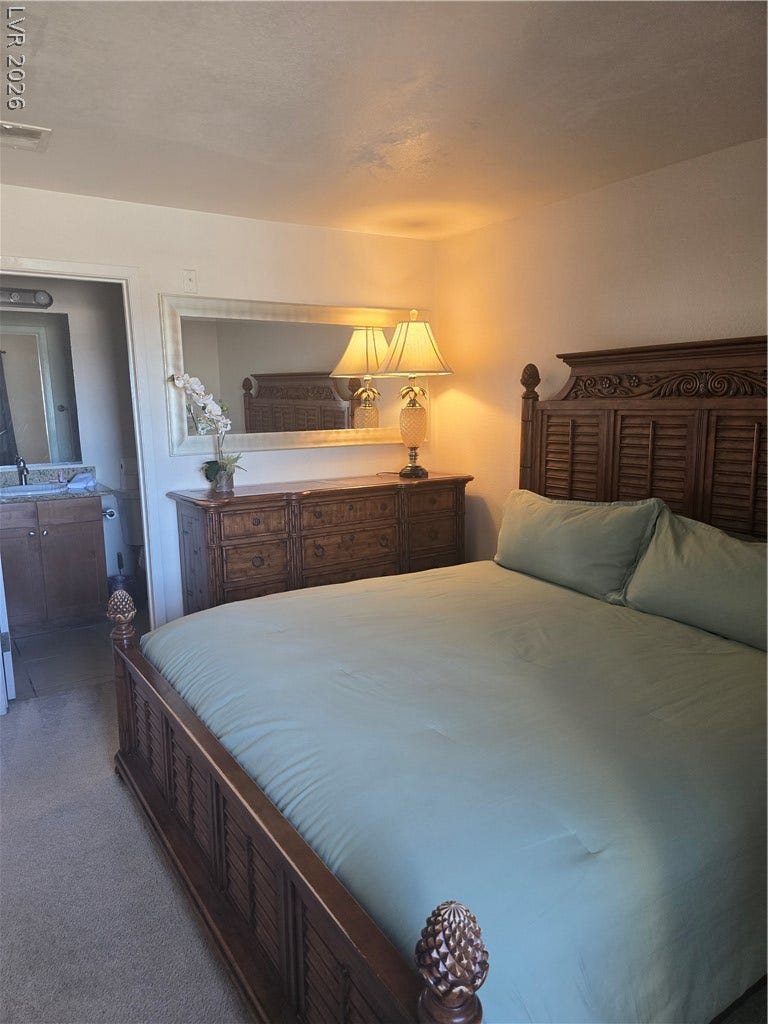 Smooth plaster walls and soft carpeting define this inviting bedroom space.