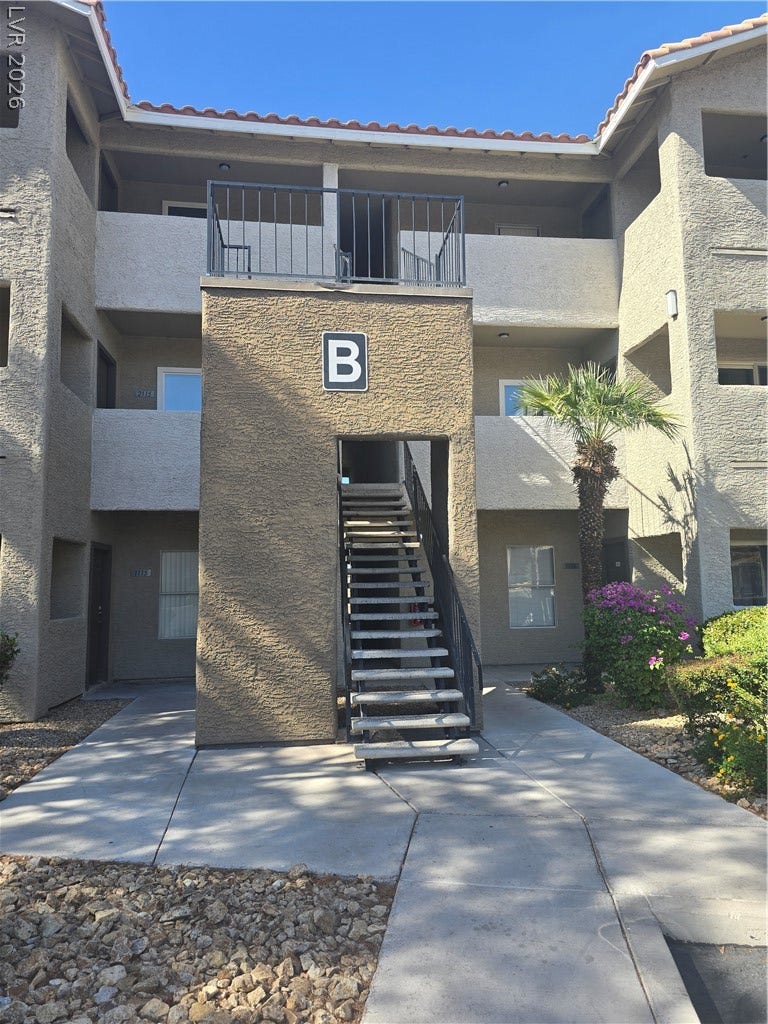 Stucco exterior finishes and tile roofing define this multi-level residential complex.