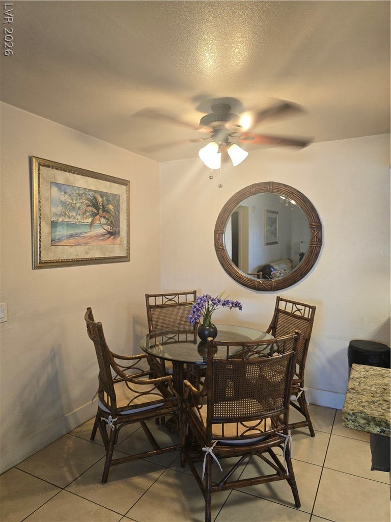 Tiled flooring runs throughout this cozy dining space adjacent to the kitchen.