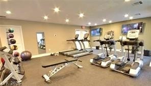 Recessed lighting illuminates this exercise facility with resilient flooring and double glass exit doors.