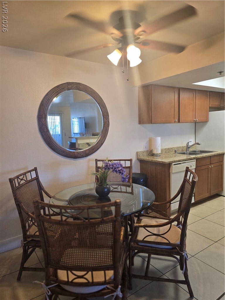 An open dining area sits adjacent to the kitchen, completed with durable tile flooring.