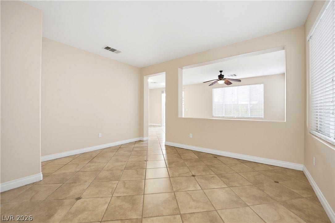 Durable tile flooring highlights this versatile space featuring a wide interior pass-through window.