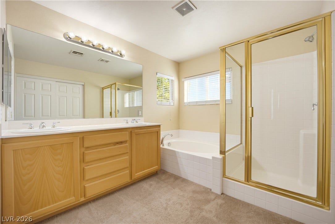 An integrated soaking tub and separate shower stall highlight this spacious bathroom layout.