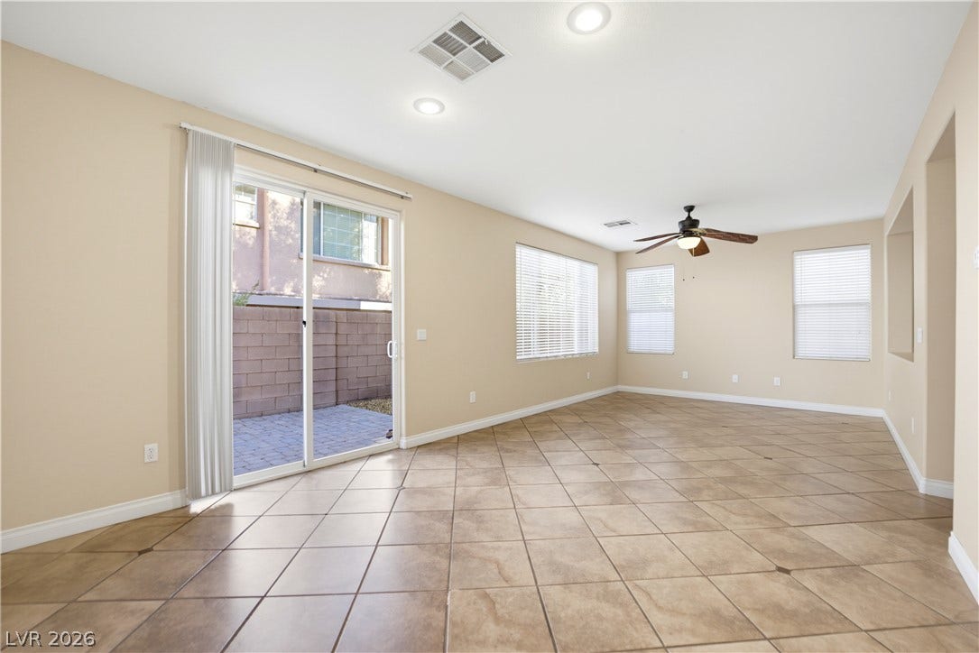 Sliding glass doors open to the patio from this spacious tile-floored living area.