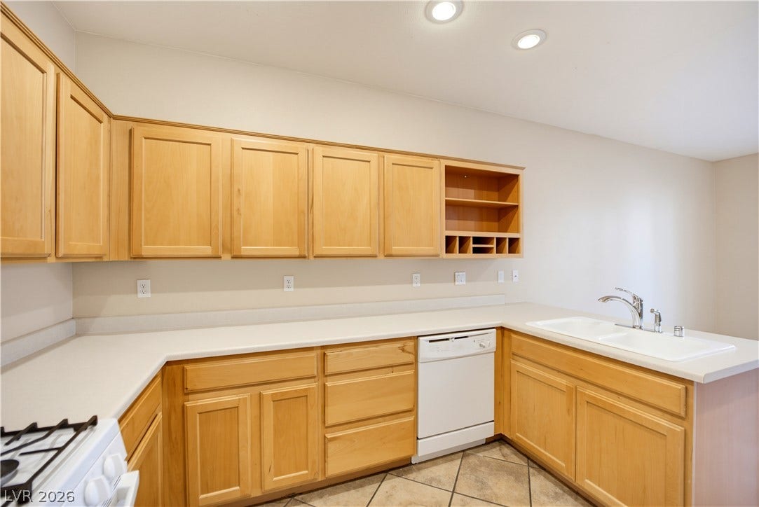 Ample wooden cabinetry and durable tile flooring define this classic kitchen space.