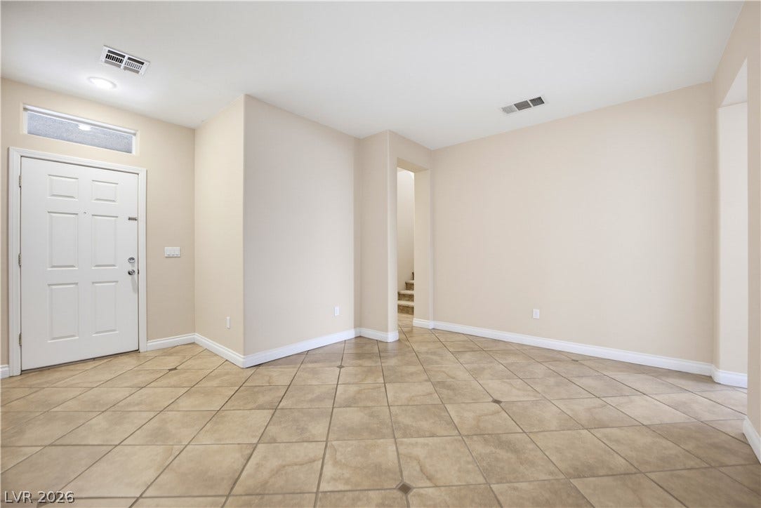 Durable tile flooring and a neutral color palette welcome visitors in the entry foyer.
