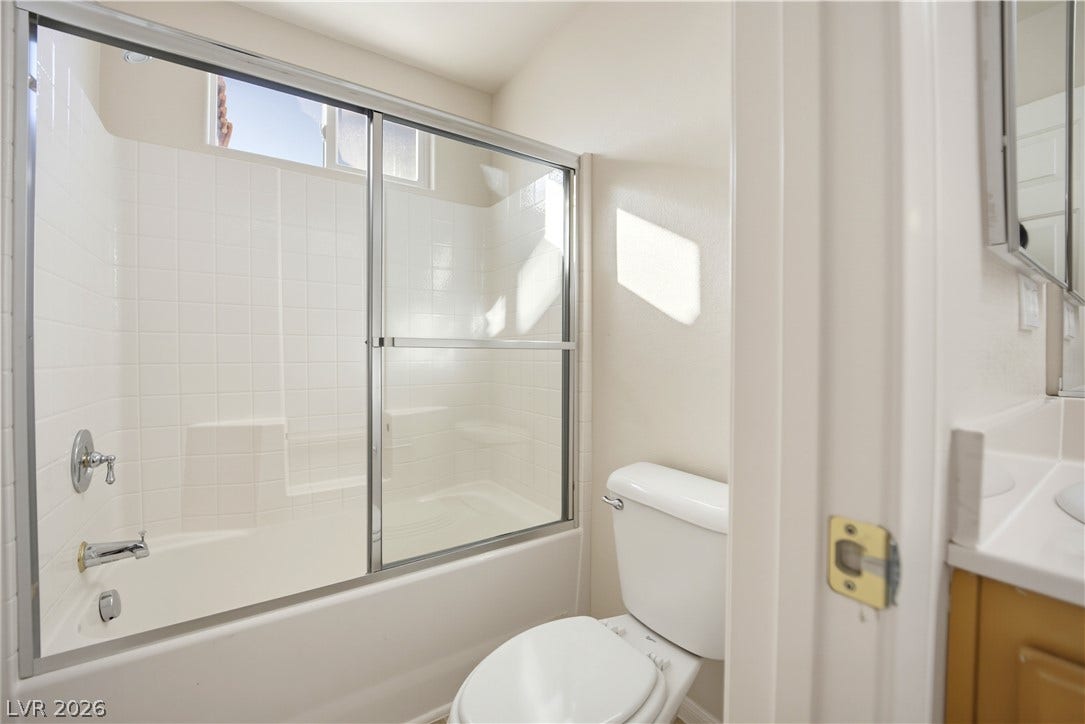 Clean lines and a tiled shower-tub combination define this functional bathroom space.