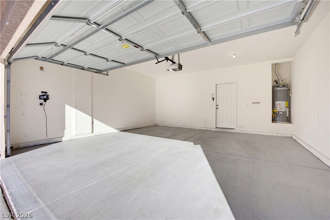 An attached two-car garage features durable concrete flooring and direct interior access.