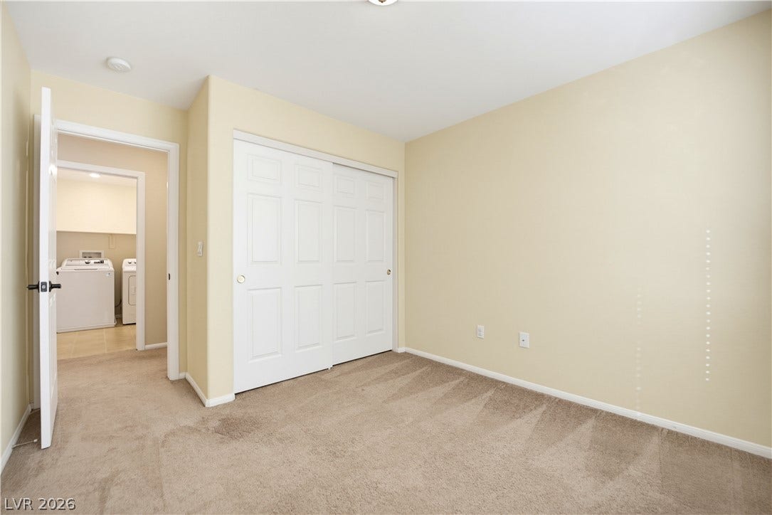 Plush carpeting anchors this quiet bedroom complete with a generous sliding door closet.