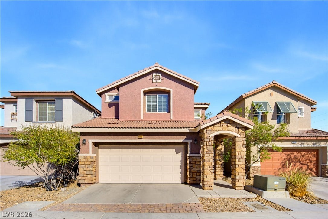 Earth-toned exterior surfaces pair with textured stone accents to create a welcoming entrance.