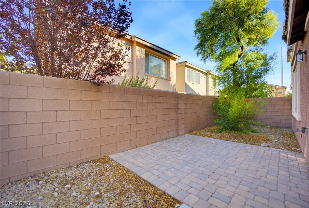 An enclosed brick-walled patio area provides a private outdoor retreat.