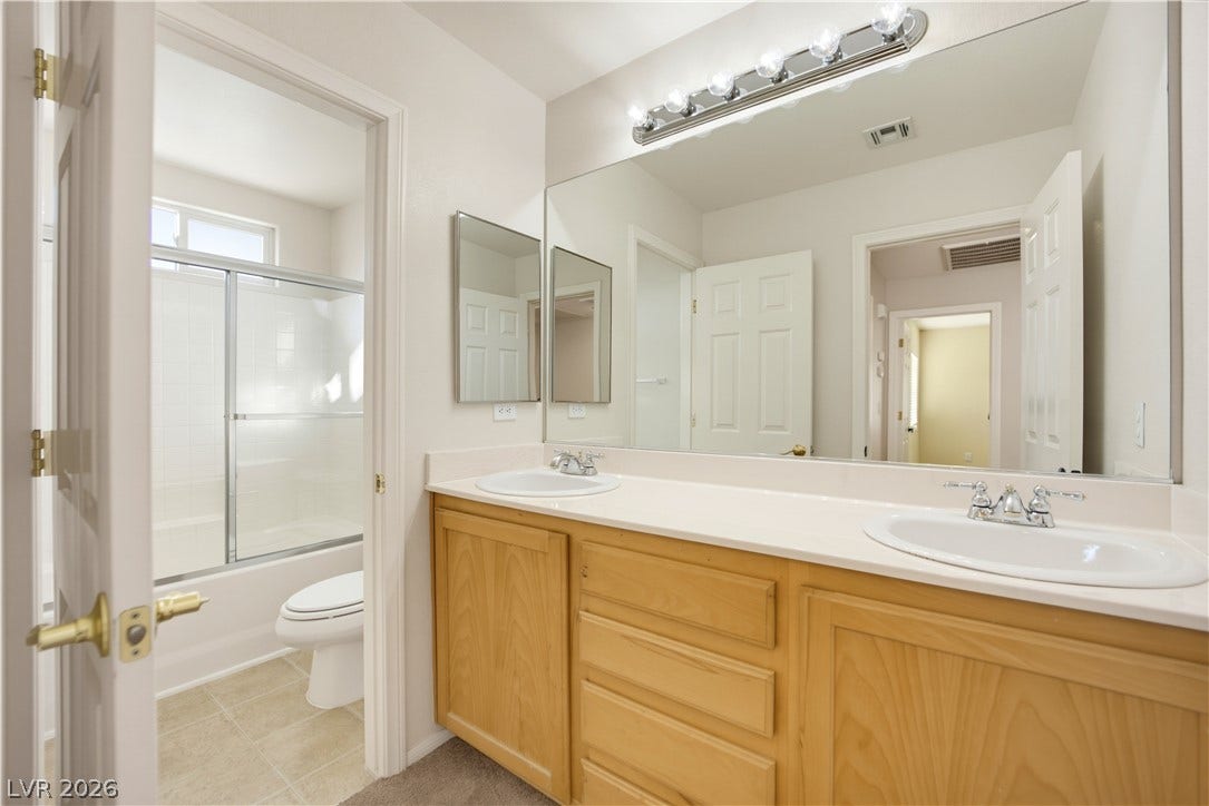 A spacious double vanity anchors this modern bathroom layout.
