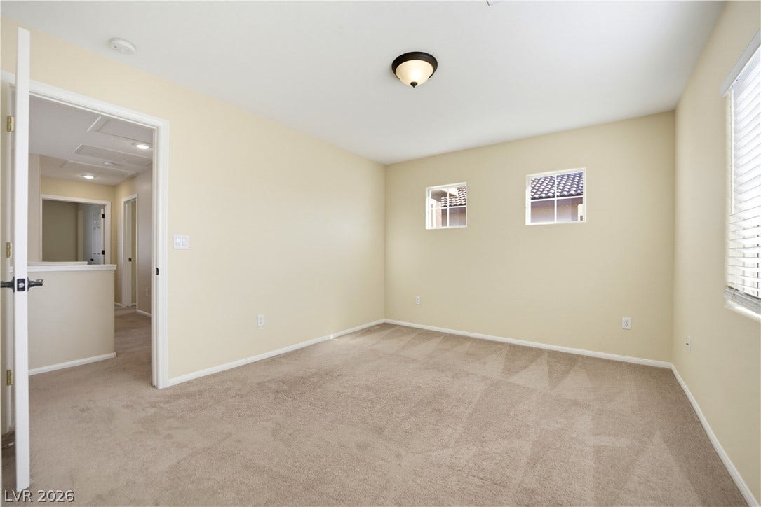 Plush carpet flooring and neutral walls anchor this versatile second-floor bedroom.